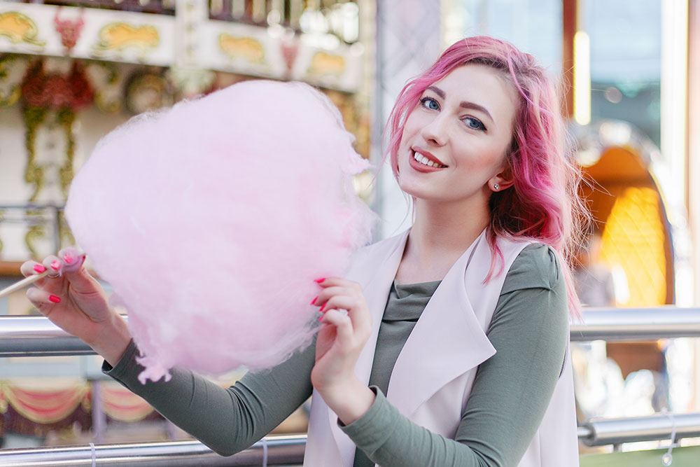 Lady happily enjoying cotton candy