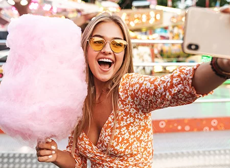 Cotton candy factory vending machine making colorful candy at theme park