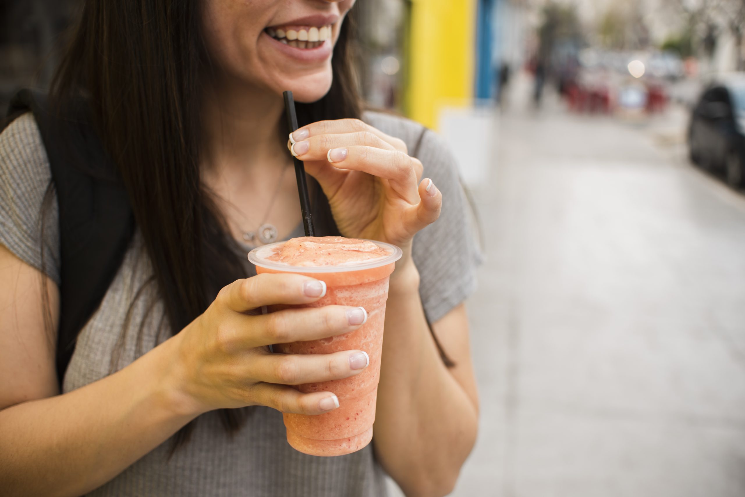 Freshly blended fruit smoothie dispensed into cup 