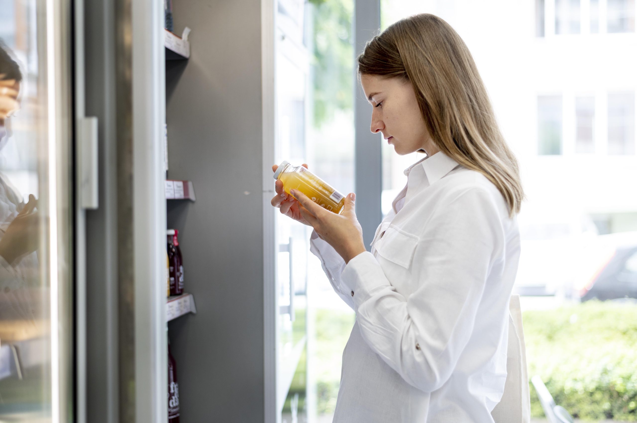 User interacting with touchscreen to select smoothie flavor  