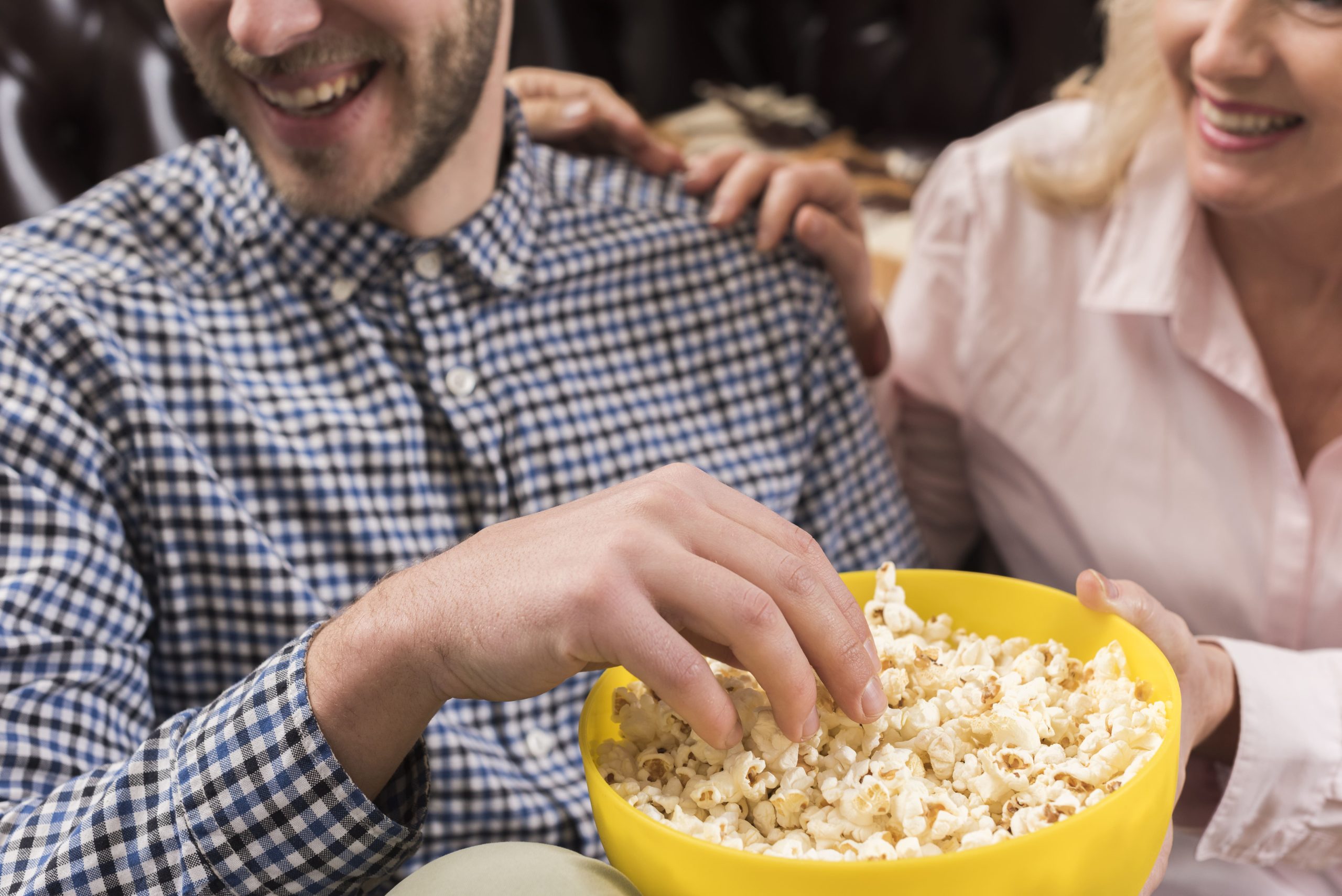 Compact cashless popcorn vending machine installed in an airport lounge providing quick snacks for travelers and office staff